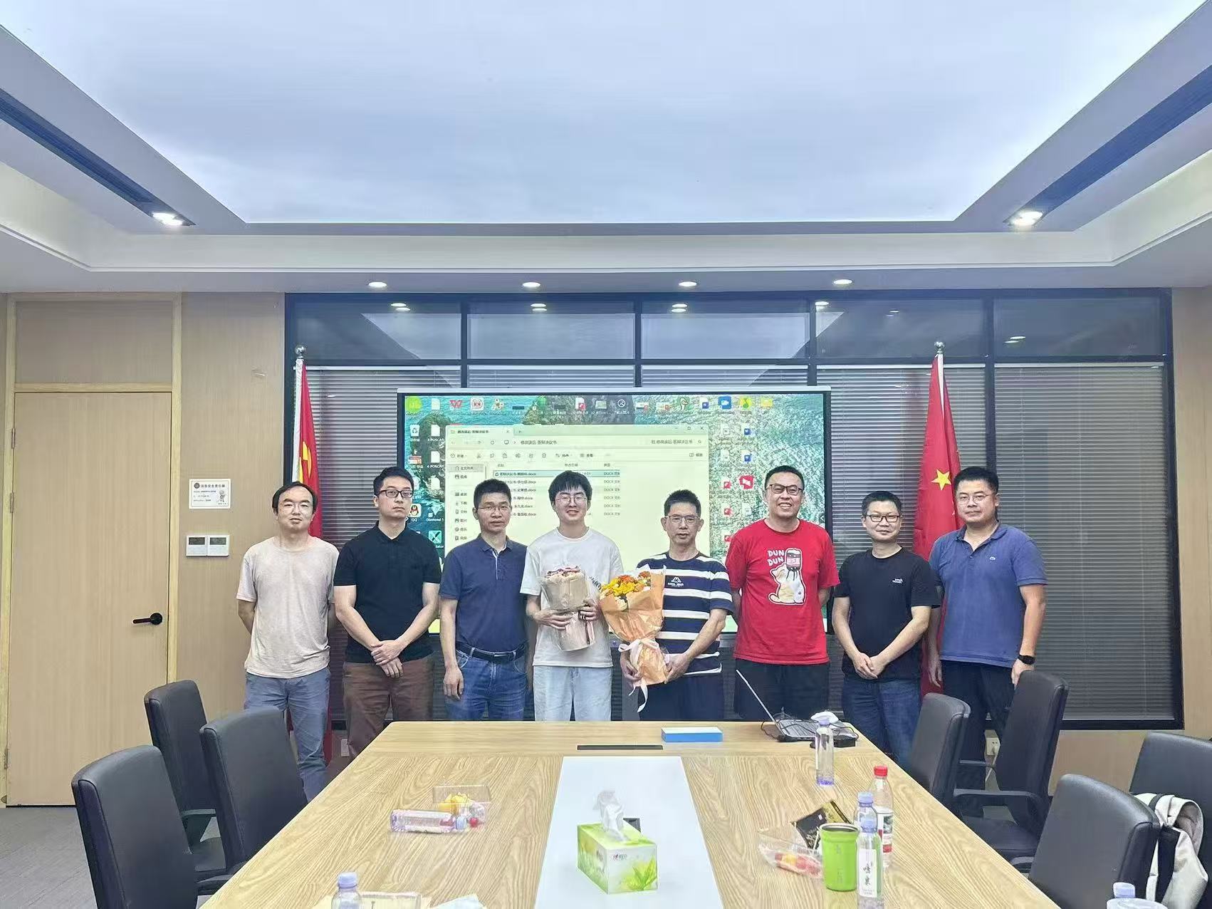 Celebration photo with Dr. Liu, Dr. Hu, and colleagues after successfully defending my Master's dissertation